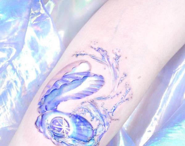Pearl in shell with wave tattoo