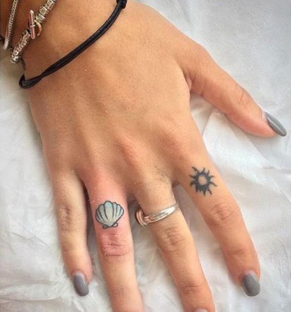Scallop shell finger tattoo