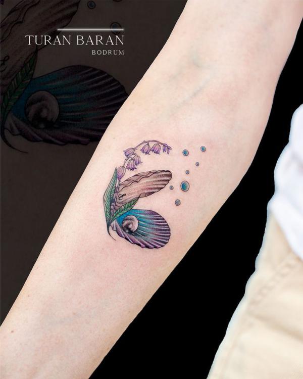 Shell and pearls with lily of the valley tattoo