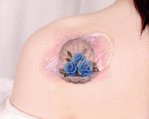 Shell with blue rose tattoo