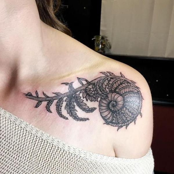 Shell with fern clavicle tattoo