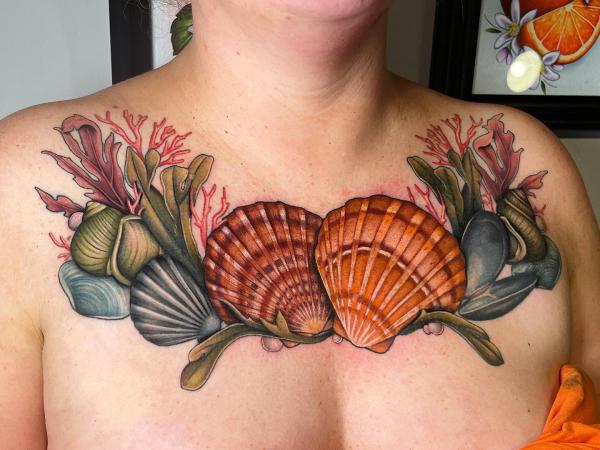 Shell with ocean plants chest tattoo