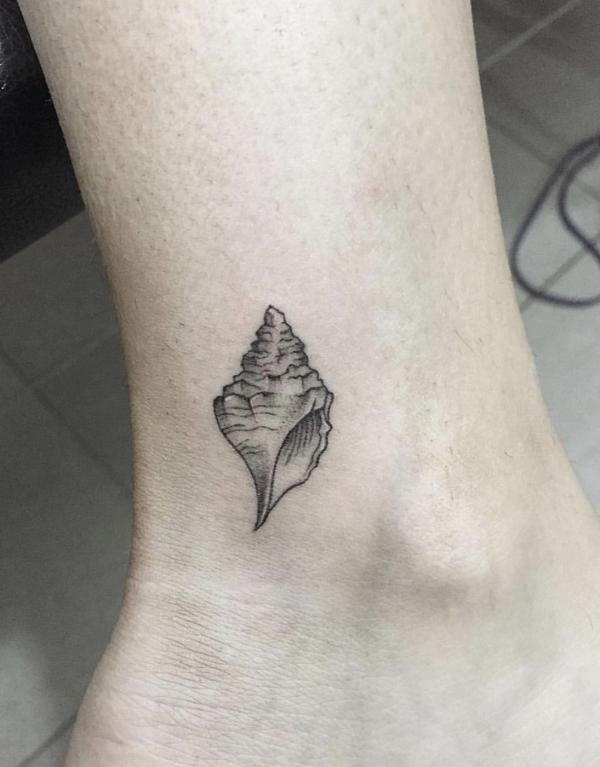 Small conch ankle tattoo