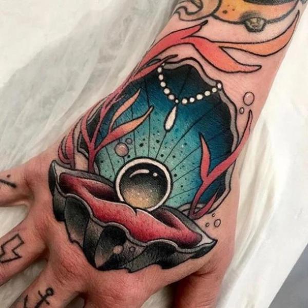 Traditional pearl in shell hand tattoo