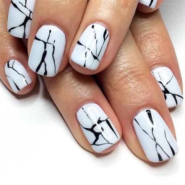 Nothing like making your nails into your personal works of art with water marble nail art design using white as your base color and black for the dripping details.