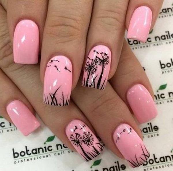 Glamorous nail art with dandelions outlined on the baby pink nails.