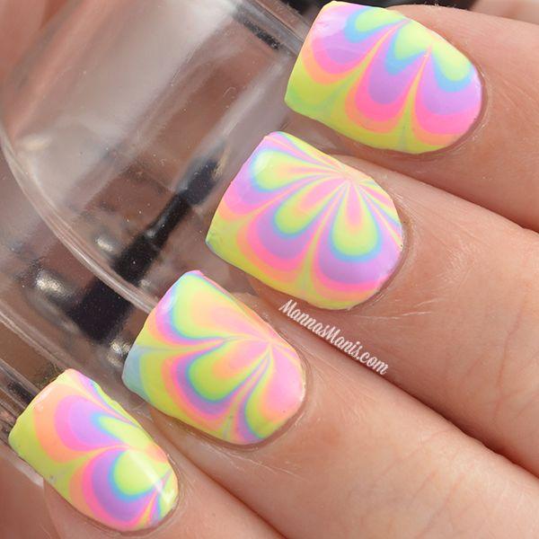 Pastel colored water marble nail art design in shape of flower pattern,