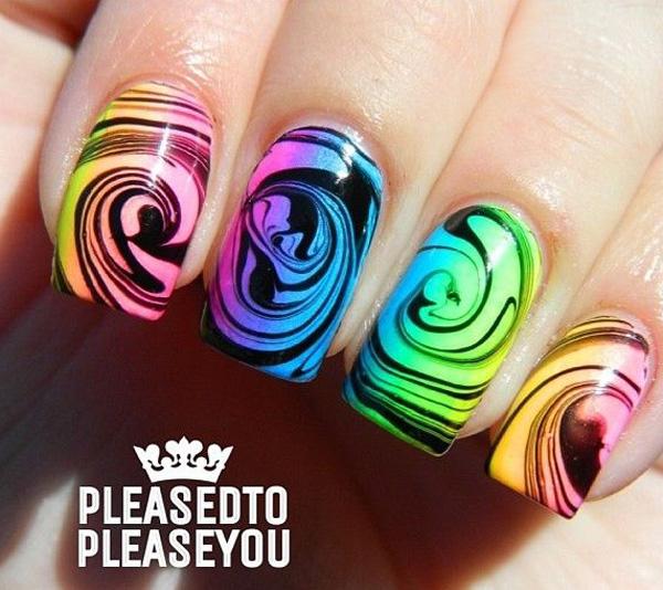 Another swirling marble nail art effect in neon colors against a black base polish.