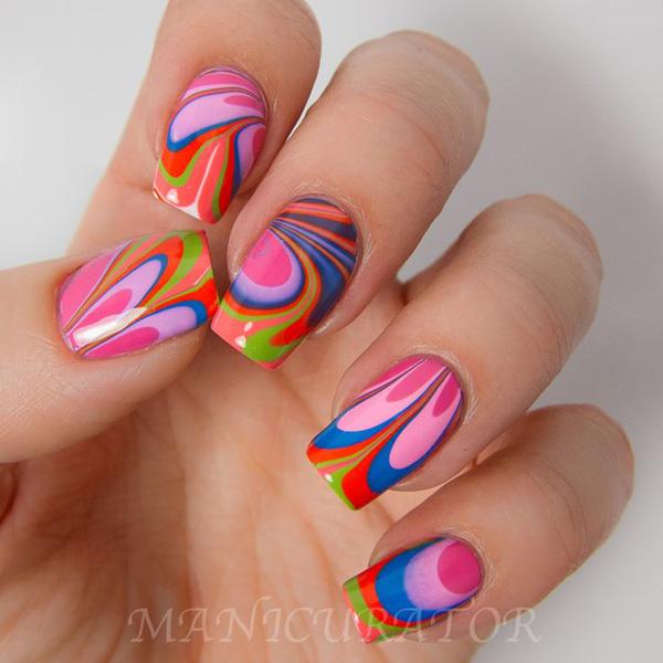 Candy colored water marble nail art design in pink, blue, orange and green polishes.
