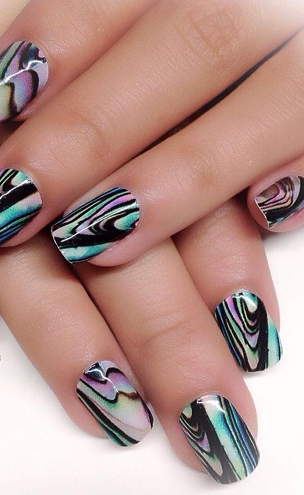 Awesome looking water marble nail art design in abstract pattern on top of a black base polish