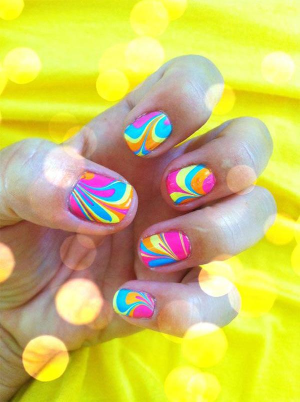 Play along with various colors with this water marble nail art design in pink, yellow, orange and blue combos.