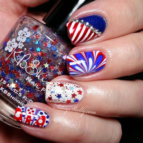 Add sparkle to your Fourth of July theme with a white, red and blue flower patterned water marble nail art design.