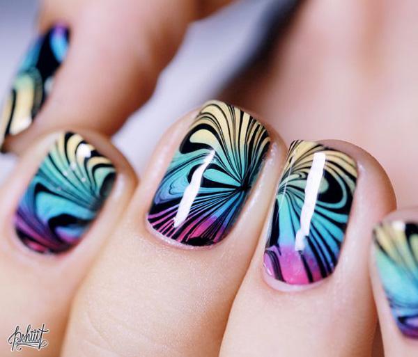 Make your gradient nails perfect by adding water marble nail art designs using black polish and creating flower patterns.