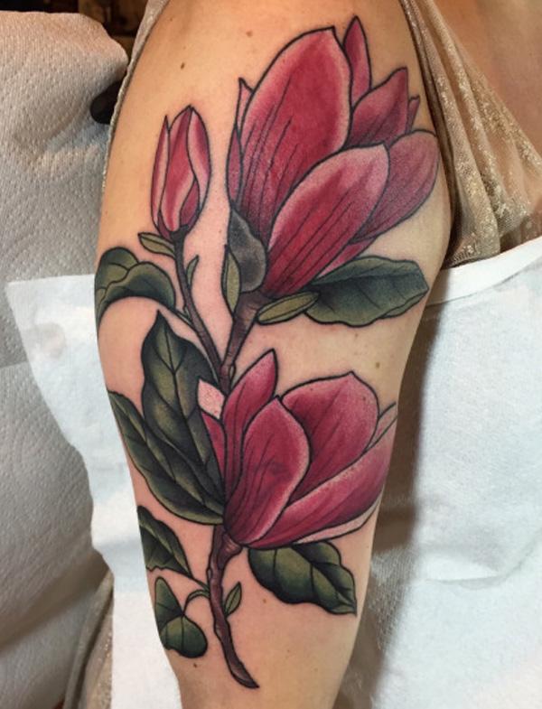 Black and white magnolia forearm sleeve tattoo in a realistic style. 