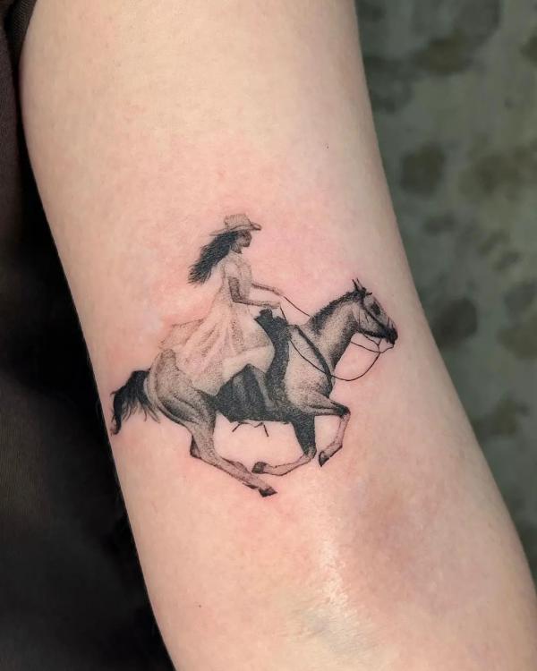 A lady riding a horse tattoo