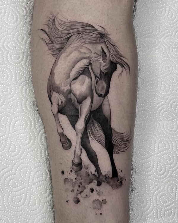 Black and grey horse arm tattoo