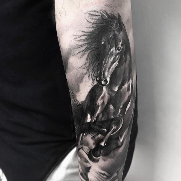 Black horse arm tattoo