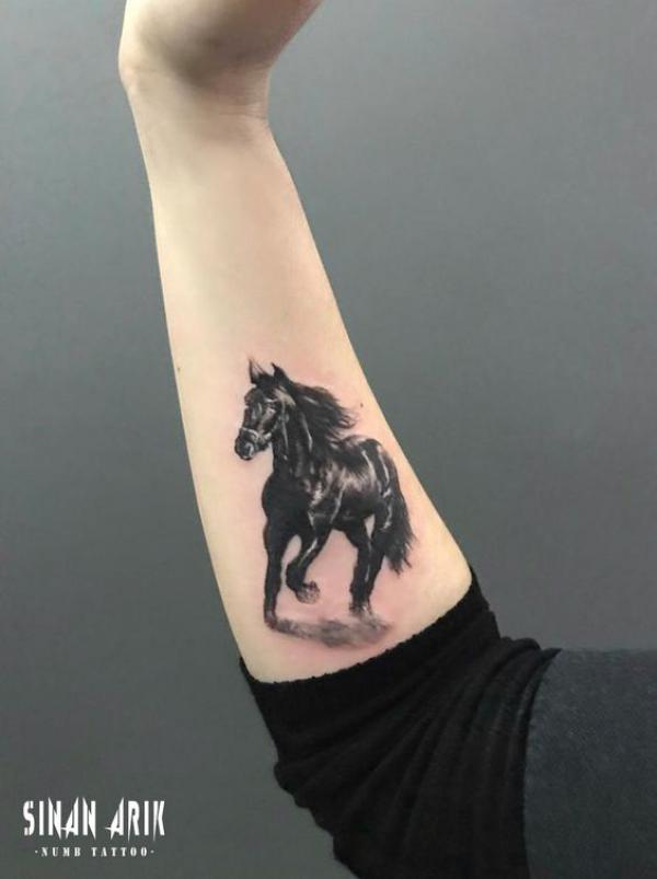 Black horse forearm tattoo