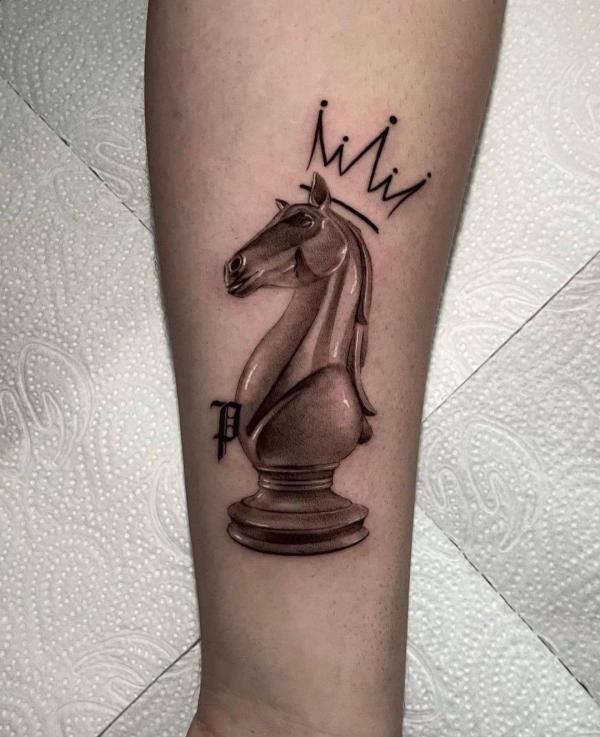 Chess horse with crown tattoo