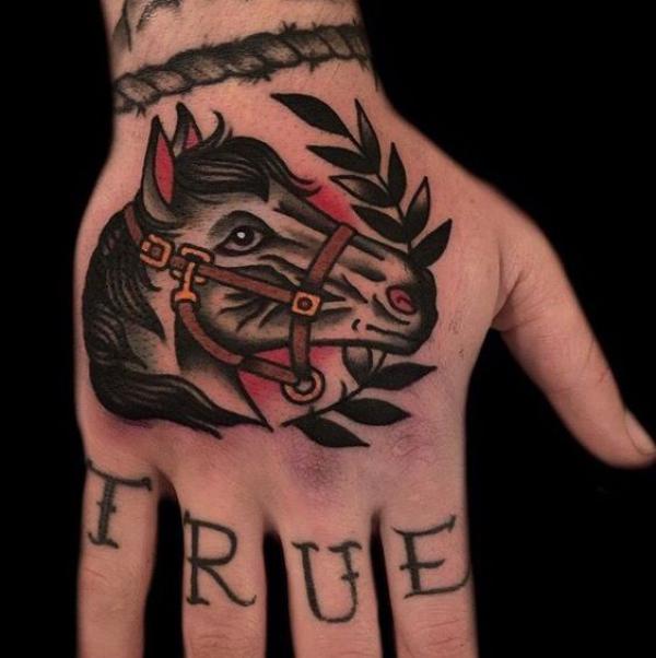 Horse head with laurel wreath hand tattoo traditional