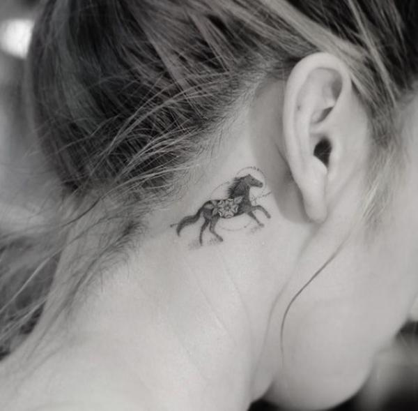 Mini floral horse tattoo behind ear