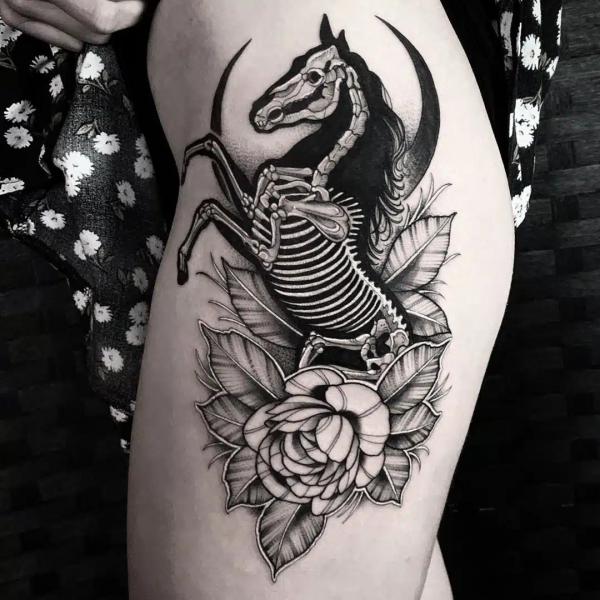 Skeleton horse with moon and flower tattoo
