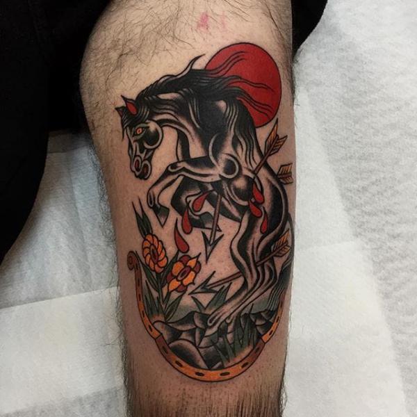 Traditional horse and horseshoe knee tattoo