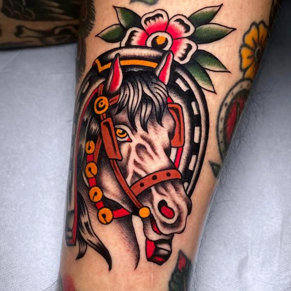 Traditional horse head with horseshoe tattoo