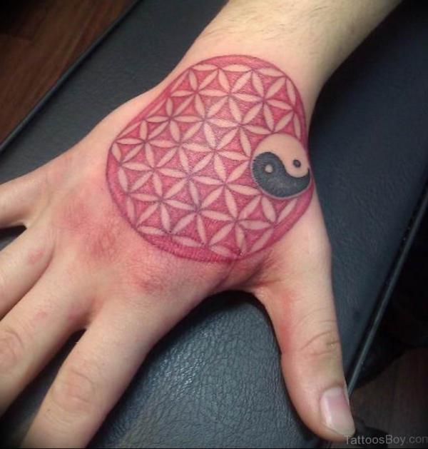 Flower of life with yinyang symbol tattoo on hand