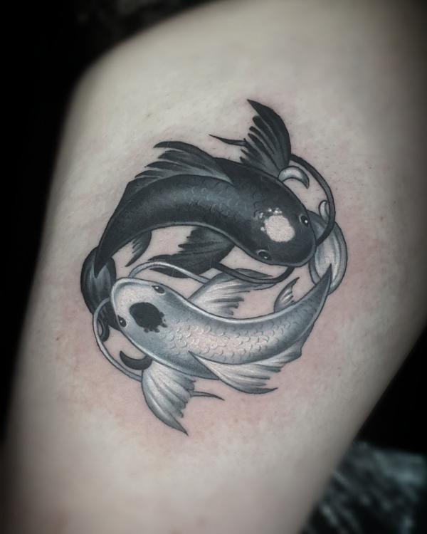Yin yang fish thigh tattoo