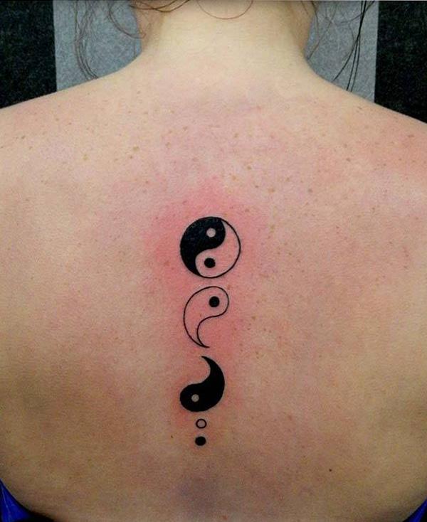 Small semicolon Yin Yang spine tattoo