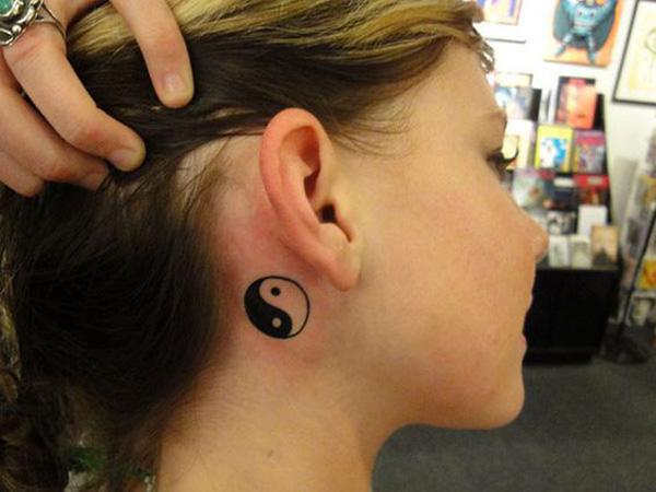 Small Yin Yang tattoo behind the ear