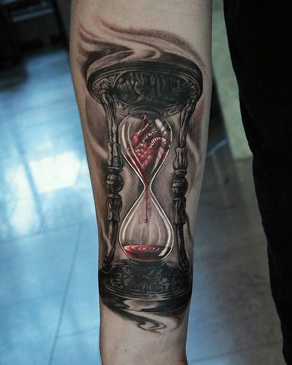 Landscape hourglass tattoo on the right inner forearm