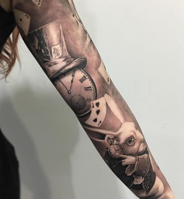 A clock with top hat and the white rabbit sleeve Tattoo