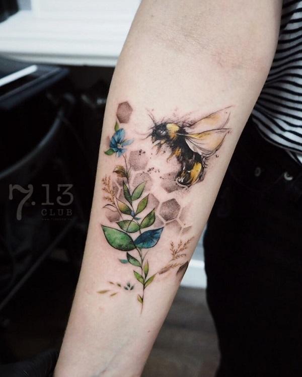 Bee tattoo on forearm in watercolor style