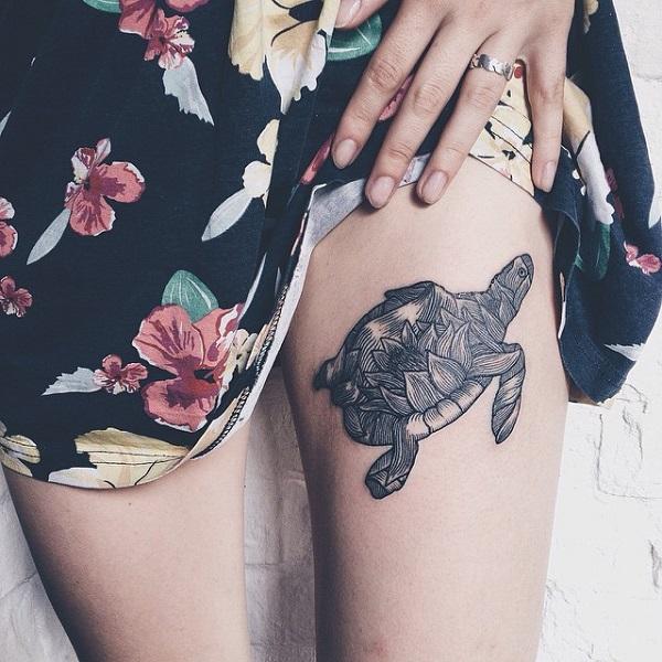 Black and grey turtle with lotus shell thigh tattoo