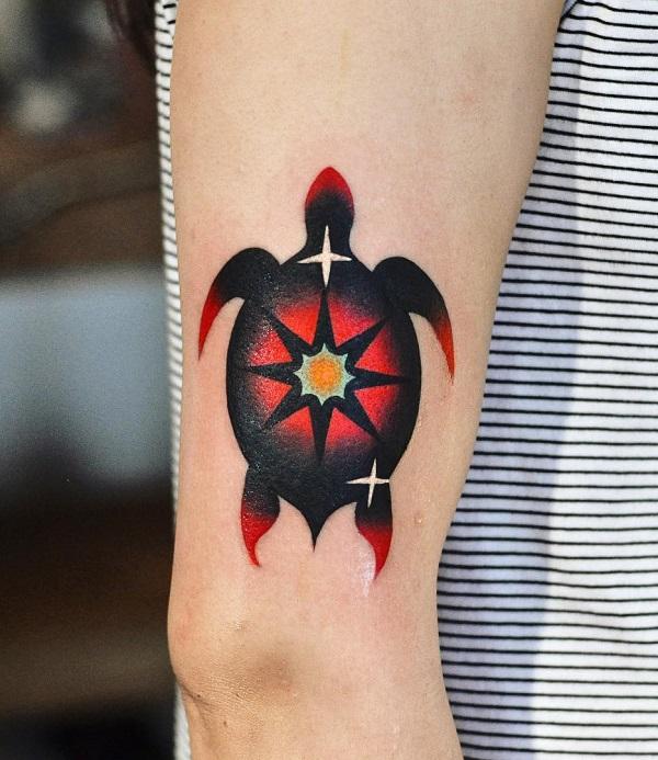Stylized black and red turtle with star tattoo