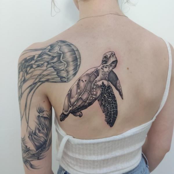 Black and grey turtle and jellyfish tattoo