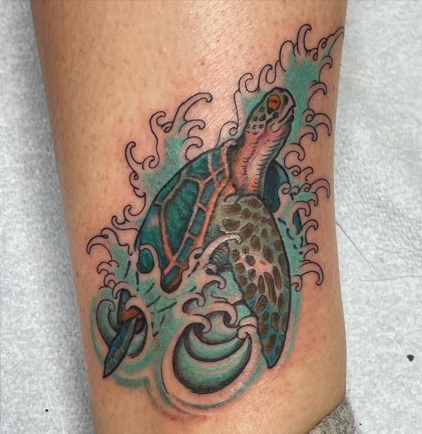 Sea turtle in wave tattoo