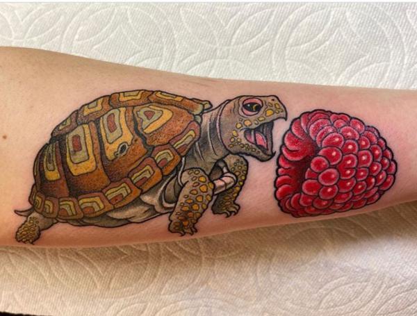 Turtle and strawberry forearm tattoo