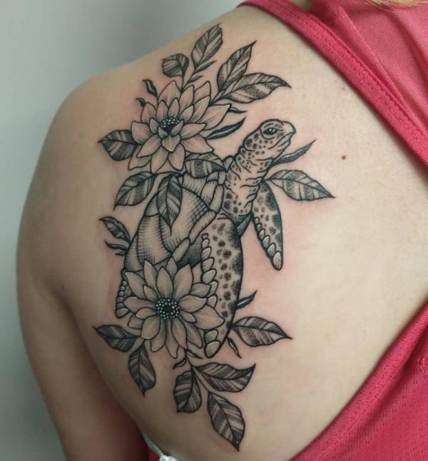 Turtle with flowers tattoo on shoulder blade
