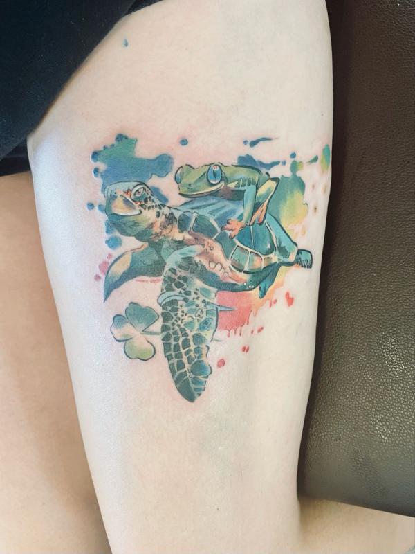 Watercolor turtle carrying frog tattoo