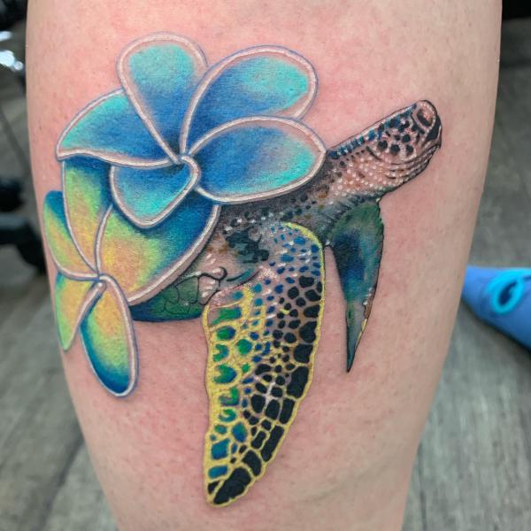 sea turtle with blue plumeria tattoo