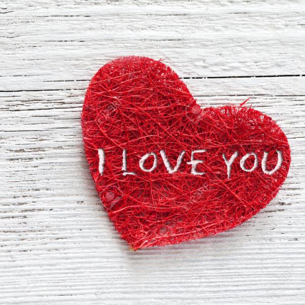 red heart on wooden background with text