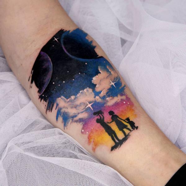 Silhouette family and watercolor sky tattoo