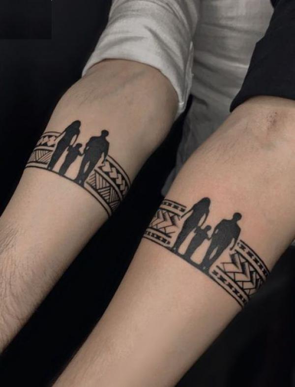 Silhouette family with tribal armband tattoo