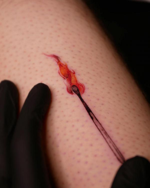 A small tattoo of Burning matchstick