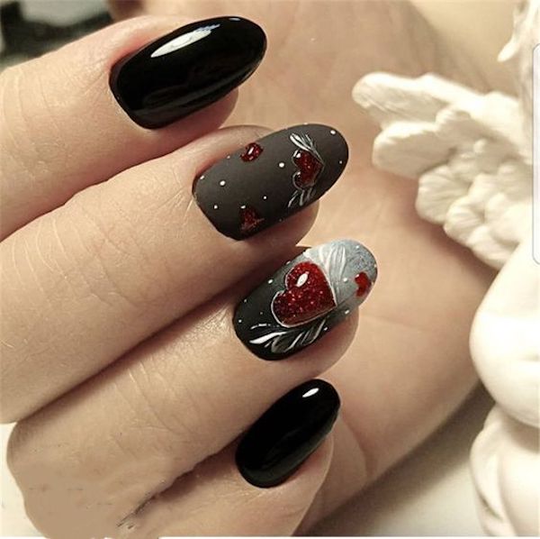 Almond nails with a crimson heated rhinestone 