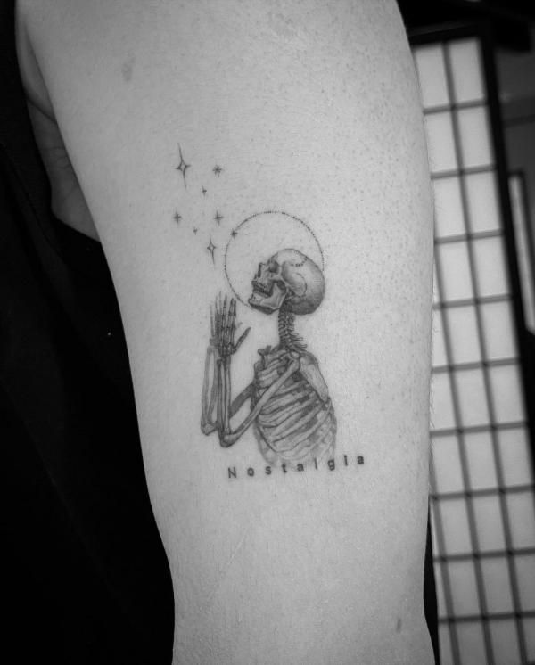 Minimalist tattoo of Praying skeleton and skull