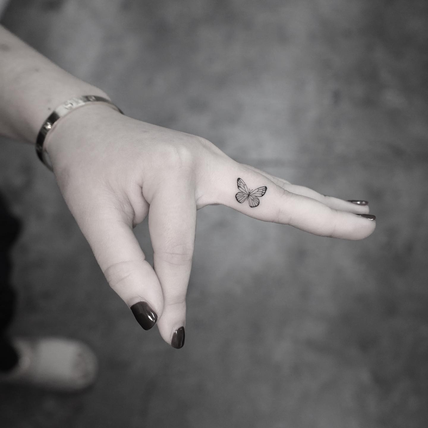 Adorable tattoo of a butterfly on the middle finger